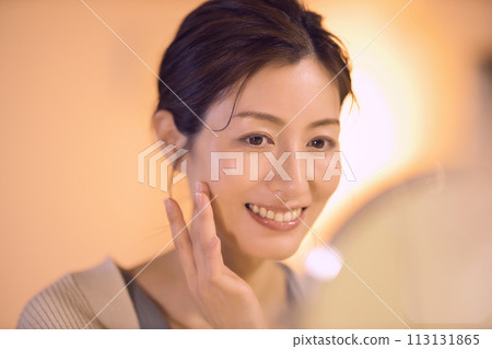 Middle-aged woman doing night skin care Middle-aged woman doing night skin care 113131865
