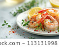 Freshly grilled shrimp adorned with herbs, sprinkled spices, and lemon accents on white plate 113131998