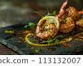 Grilled prawns on slate with lemon zest, herbs, and spices, capturing the rich essence of seafood. 113132007