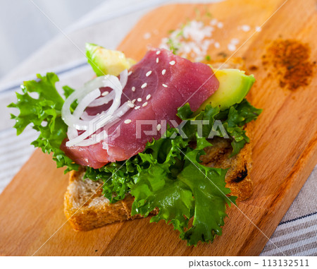 Toast with raw tuna and avocado 113132511