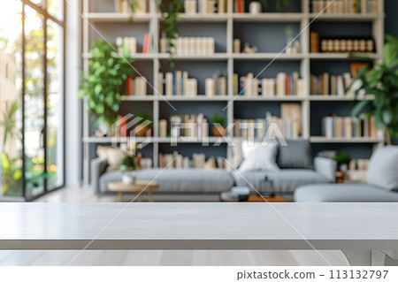 A white room with a wooden table and a shelf full of books 113132797