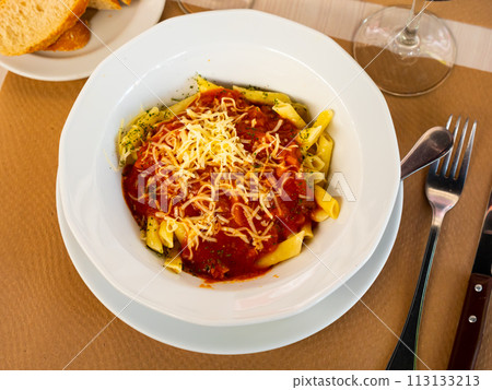 Pasta bolognese with cheese served on platter Pasta bolognese with cheese served on platter 113133213