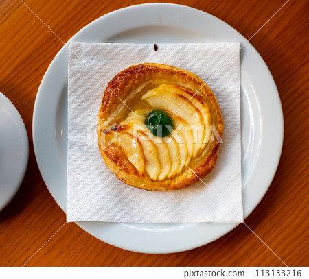 Round small apple pie served in a plate 113133216