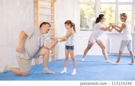 Father and daughter training self-defense techniques 113133248