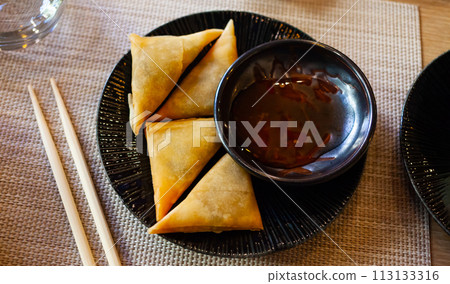 Samosas filled with curry leaves 113133316