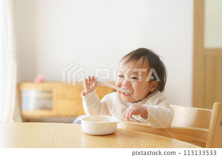 Baby eating baby food Baby eating baby food 113133533