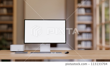 A wooden table features a PC computer mockup, a computer desk in a contemporary home office. 113133704