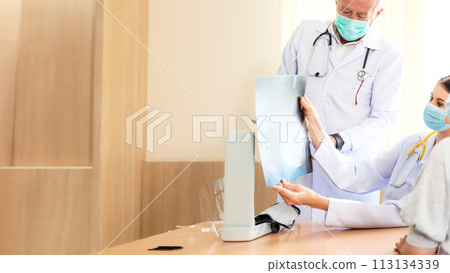 Doctor Team examining and checking at chest and lung x ray film  Doctor Team examining and checking at chest and lung x ray film  113134339