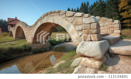 Medival stone bridge acrooss the stream 113134891