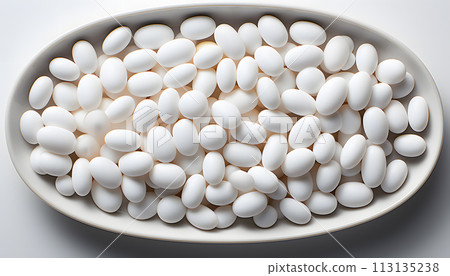 White pills on blue background 113135238