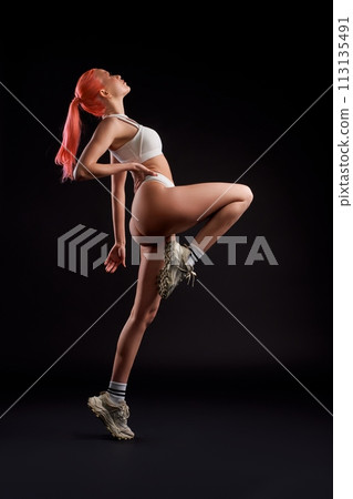 Dynamic photo of sporty woman in sportwear running ahead Dynamic photo of sporty woman in sportwear running ahead 113135491