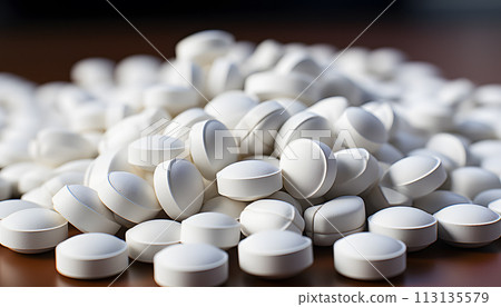 White pills on blue background 113135579