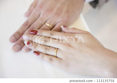 Wedding rings on the hands of the bride and groom 113135758
