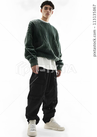 Man in green jersey and black active pants on white background 113135867