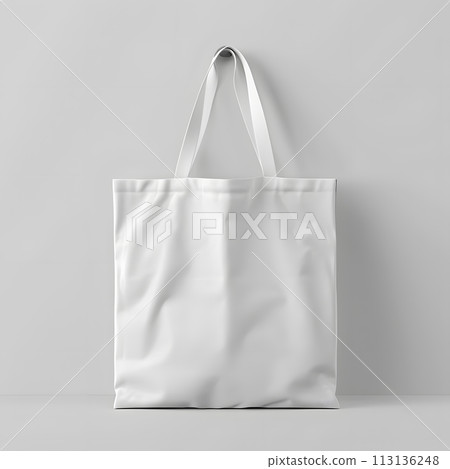 White tote bag on white wall, sleek and stylish fashion accessory White tote bag on white wall, sleek and stylish fashion accessory 113136248