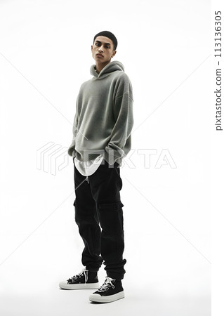 A man in sportswear with hoodie and black pants on white background A man in sportswear with hoodie and black pants on white background 113136305