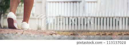 Banner Woman traveller walking on road relaxation. Women wear sneaker shoes walking summer park. Females standing green park on forest pathway outdoors. Traveler relaxing walk way with copy space Banner Woman traveller walking on road relaxation. Women wear sneaker shoes walking summer park. Females standing green park on forest pathway outdoors. Traveler relaxing walk way with copy space 113137028