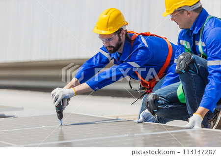 Engineer set installing and inspect standards of solar panels on roof of an industrial factory. Engineer set installing and inspect standards of solar panels on roof of an industrial factory. 113137287