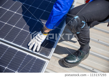 Technicians are installing and inspecting standards of solar panels on roof of an industrial. 113137293