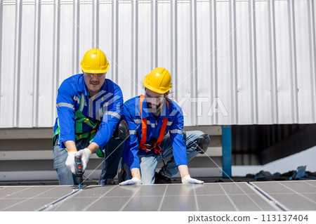 Engineer set installing and inspect standards of solar panels on roof of an industrial factory. 113137404