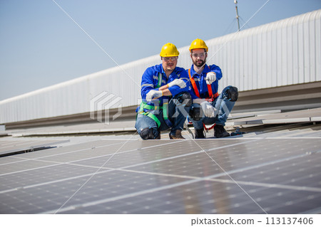 Engineer set installing and inspect standards of solar panels on roof of an industrial factory. 113137406