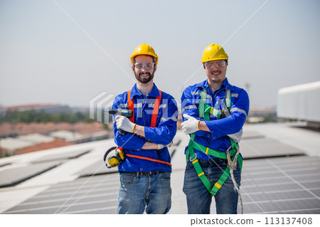 Engineer set installing and inspect standards of solar panels on roof of an industrial factory. Engineer set installing and inspect standards of solar panels on roof of an industrial factory. 113137408