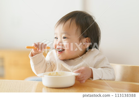 Baby eating baby food 113138388