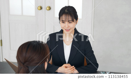 two women talking in the office 113138455
