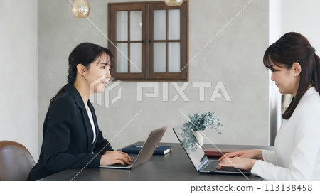 Two businesswomen meeting in a casual office Two businesswomen meeting in a casual office 113138458