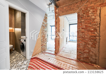 Comparison of old apartment before restoration and new renovated flat with modern interior design. Apartment with underfloor heating pipes and washing machine in bathroom before and after renovation. 113138625