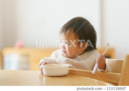 Baby eating baby food Baby eating baby food 113138697