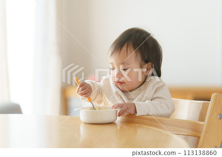 Baby eating baby food Baby eating baby food 113138860