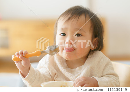 Baby eating baby food Baby eating baby food 113139149