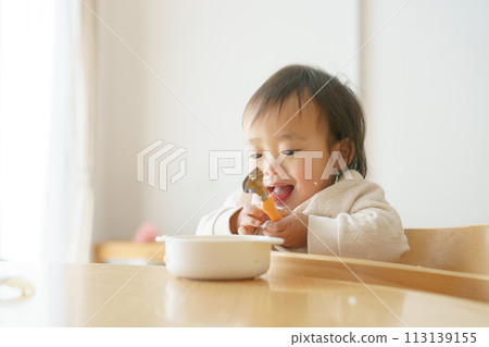 Baby eating baby food 113139155
