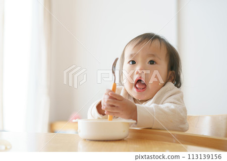 Baby eating baby food 113139156
