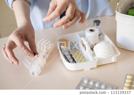 Female hands blister pills pack first kit aid storage organization. Vitamin, painkiller, cure supply 113139337
