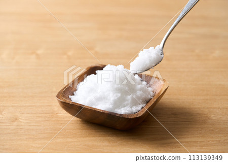 Caster sugar on a wooden plate Caster sugar on a wooden plate 113139349