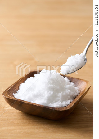 Caster sugar on a wooden plate Caster sugar on a wooden plate 113139352