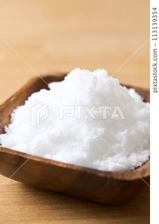 Caster sugar on a wooden plate Caster sugar on a wooden plate 113139354