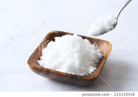 Caster sugar on a wooden plate Caster sugar on a wooden plate 113139356