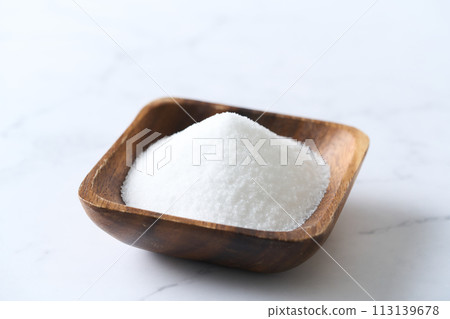 Granulated sugar on a wooden plate Granulated sugar on a wooden plate 113139678