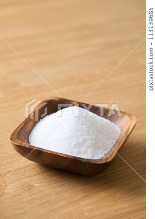 Granulated sugar on a wooden plate Granulated sugar on a wooden plate 113139685