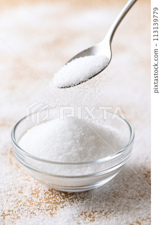 Granulated sugar on a glass plate Granulated sugar on a glass plate 113139779