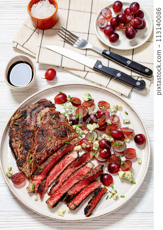 fried beef steak with salad of grape, cheese 113140086