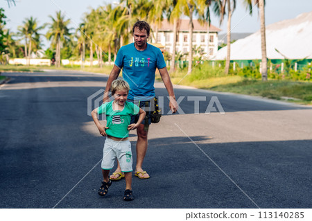 Father son have fun. Man holds child's leg upside down head. Joy happiness childhood paternity delight 113140285
