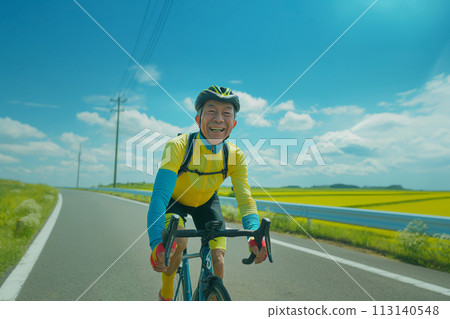 Smiling senior cycling on a road bike 113140548