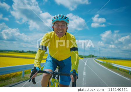 Smiling senior cycling on a road bike Smiling senior cycling on a road bike 113140551