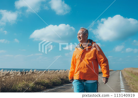 Senior man walking while looking at the sea 113140919