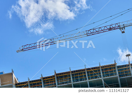 Large construction high rise crane, clear blue sky 113141327