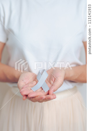 Brain Cancer Awareness May month, woman with grey color Ribbon for supporting life people. Healthcare and World cancer day concept 113141933